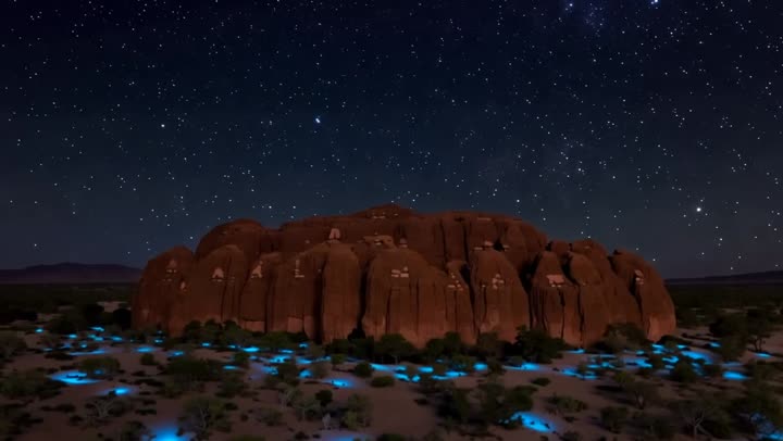 Uluru monolith under desert stars, Australia